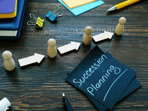 Succession planning sign and figurines with arrows. Business Succession Planning Concept.